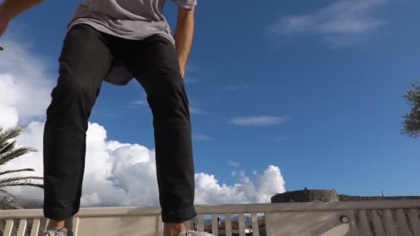 Close up of skater skateboarder man doing 360 kickflip heelflip flip trick in slow motion jump - Video