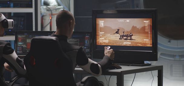 Man controlling Mars rover with remote controller - Photo, Image