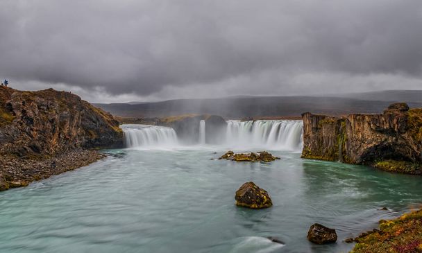 landscape of the Godafoss famous waterfall in Iceland. The breathtaking landscape of Godafoss waterfall attracts tourist to visit the Northeastern Region of Iceland. September 2019. Long exposure - Photo, Image