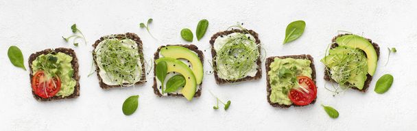 Vegetarian toasts with avocado, tofu, tomato and microgreen - Photo, Image