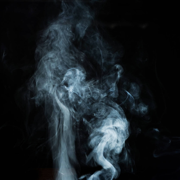 Abstract white smoke effect isolated on black background. - Photo, image