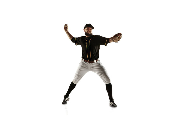 Baseball player, pitcher in a black uniform practicing on a white background. - Fotoğraf, Görsel