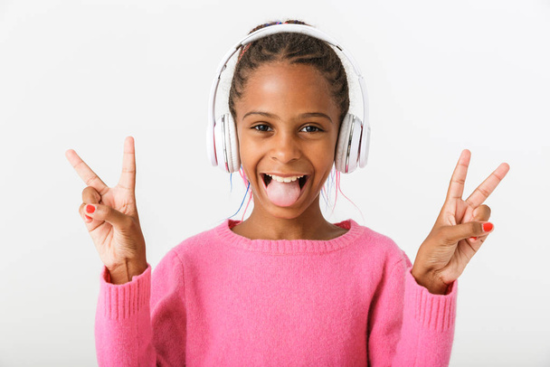 Image of funny african american girl using headphones - Photo, Image