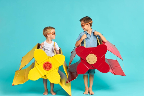 Beautiful small boys in cardboard planes - Фото, зображення