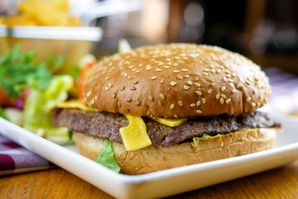 Meaty hamburger in a restaurant - Valokuva, kuva