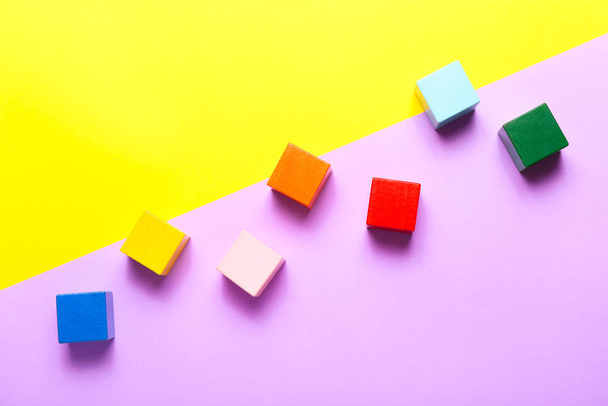 Colorful wooden cubes on colorful background. Top view, flat lay. - Fotografie, Obrázek