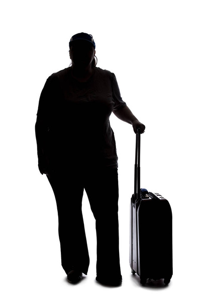 Silhouette of a curvy or plus size woman on a white background.  She is unrecognizable and is wearing casual apparel and waiting with luggage - Фото, зображення