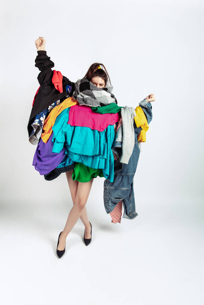 Woman addicted of sales and clothes, overproduction and crazy demand - 写真・画像