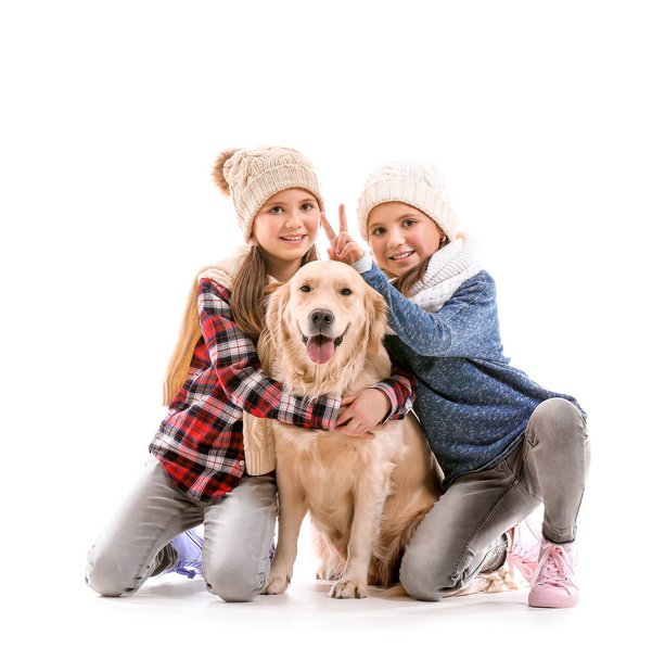 Happy girls in autumn clothes and with dog on white background - Foto, immagini