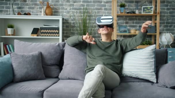 Slow motion of excited person enjoying new experience with virtual reality glasses - Video