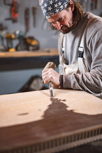 Carpenter working on a old wood in a retro vintage workshop. - Photo, Image