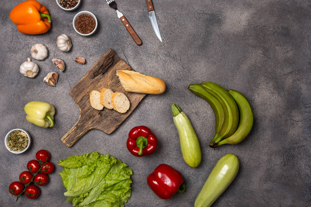 Collection of different fresh raw vegetables on a grey background. Top view - Foto, Bild