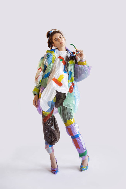 Woman addicted of sales and clothes, wearing plastic, recycling concept - Foto, immagini