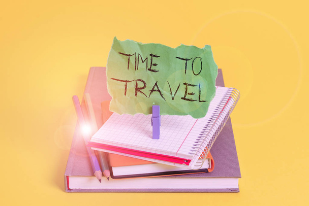 Text sign showing Time To Travel. Conceptual photo Moving or going from one place to another on vacation Book pencil rectangle shaped reminder notebook clothespin office supplies. - Photo, Image