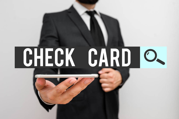 Handwriting text Check Card. Concept meaning allows an account holder to access funds in her account Male human wear formal work suit hold smart hi tech smartphone use one hand. - Photo, Image