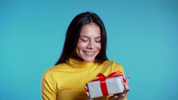 Pretty woman received gift box and interested in whats inside. She is happy - Кадры, видео