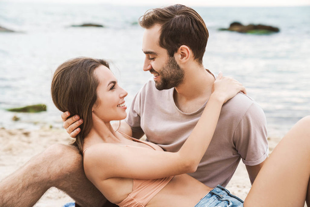 Photo of romantic beautiful couple hugging and smiling at each other - Photo, image