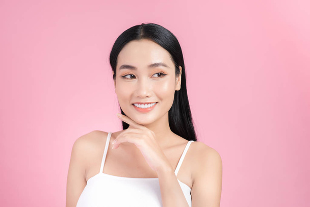 Азійська жінка-красуня Портрет ізольований на рожевому фоні зі здоровою шкірою і білими зубами посмішкою. - Фото, зображення