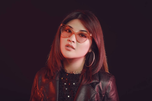 Portrait of young Asian woman on dark background - Фото, зображення