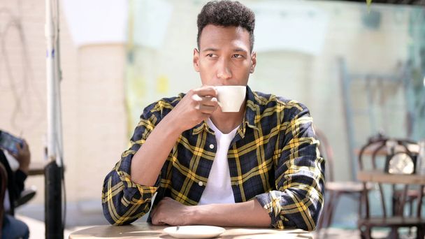 Relaxing Young African Man Drinking Coffee, Outdoor Cafe - Foto, Imagen