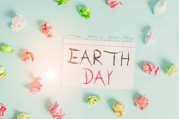 Word writing text Earth Day. Business concept for Worldwide celebration of ecology environment preservation Colored crumpled rectangle shaped reminder paper light blue background. - Photo, Image