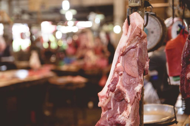 A closeup shot of raw meat on the hanger with a blurred background - Φωτογραφία, εικόνα