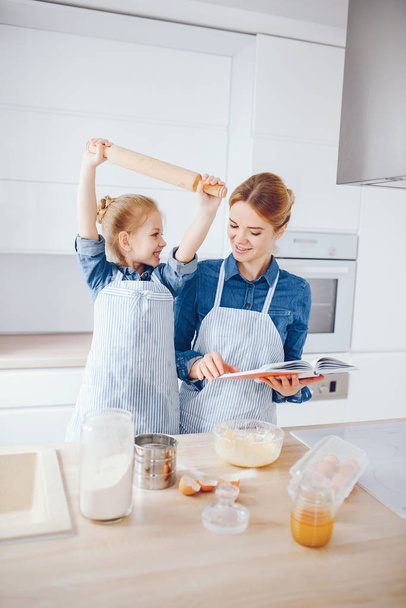 mother with daughter in the kitchen - Photo, image