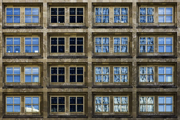 A modern building with glass windows silently witnessing the life of the big city - Zdjęcie, obraz