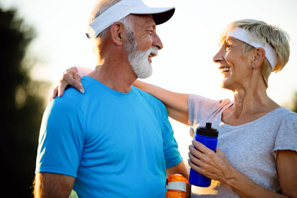 Beautiful sporty senior couple staying fit with running and jogging - Fotoğraf, Görsel