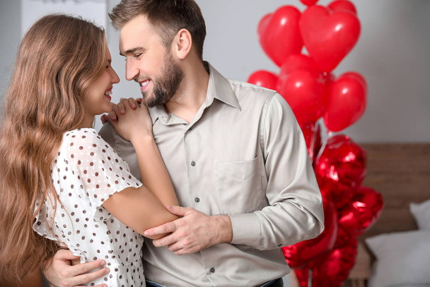 Happy young couple celebrating Valentine's Day at home - Foto, Imagem