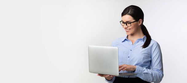 Businesswoman Using Laptop Working Online Standing In Studio, Panorama - 写真・画像