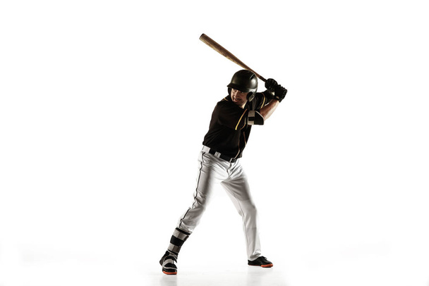 Baseball player, pitcher in a black uniform practicing on a white background. - Foto, Bild