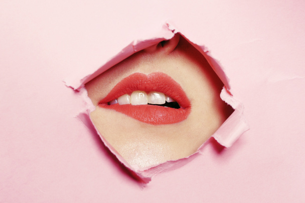 Girl bites her lip, erotic store. Big beautiful lips, beauty sal - Photo, Image
