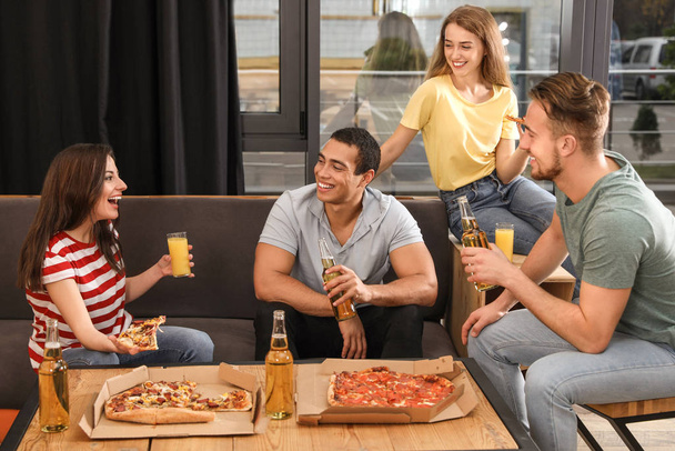 Group of friends having fun party with delicious pizza in cafe - Foto, Bild