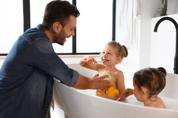 Young father with little daughters in bathroom - Fotoğraf, Görsel