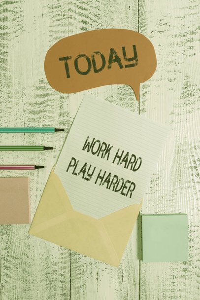 Writing note showing Work Hard Play Harder. Business photo showcasing a Balance Life Have a Break Destressing to Relax Envelop speech bubble paper sheet ballpoints notepads wooden background. - Photo, Image