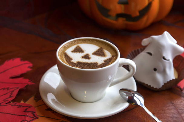 cup of cappuccino coffee with halloween symbol latte art on milk foam - Φωτογραφία, εικόνα