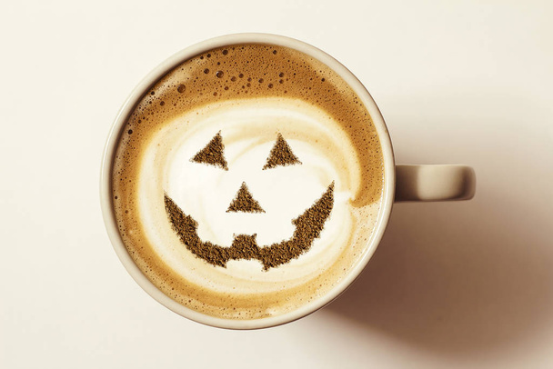 a cup of cappuccino coffee with a picture of a halloween symbol from cinnamon on milk foam - Foto, Bild