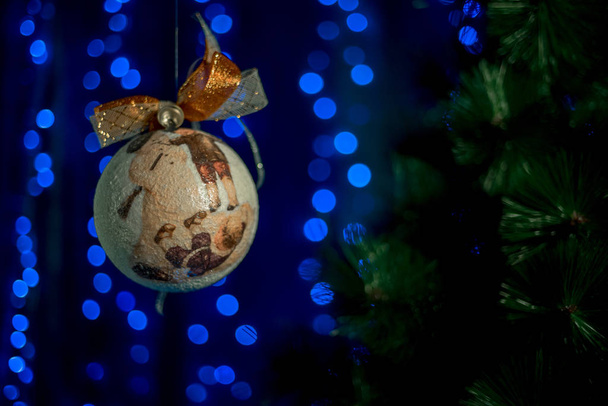 homemade vintage Christmas ball rolling in the air near NewYears Tree.  - Photo, Image