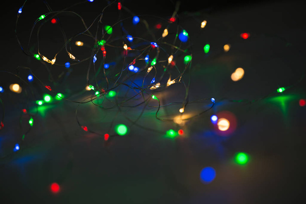 Christmas lights on dark background with copy space. Decorative garland - Zdjęcie, obraz