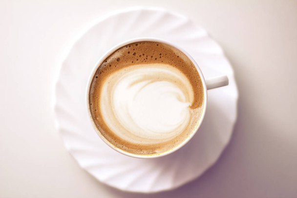 Top view of hot coffee cappuccino latte art in a ceramic glass - Fotoğraf, Görsel