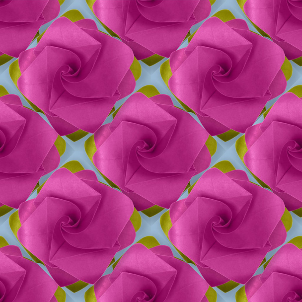 Pink purple paper origami handmade rose on blue pattern - Fotografie, Obrázek
