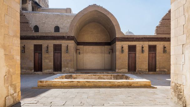 Courtyard of mosque of Sultan Al Nassir Qalawun with side arched iwan and wooden doors, Cairo, Egypt - Photo, Image