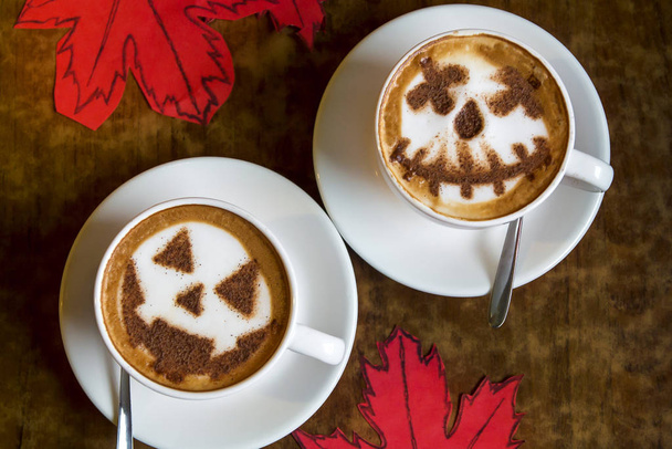 two cups of cappuccino coffee with halloween symbol latte art on milk foam - Φωτογραφία, εικόνα