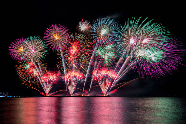 Красочные фейерверки различных цветов в ночное время с празднованием
 - Фото, изображение