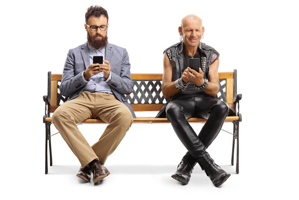 Bearded man and a punker sitting on a bench and typing on mobile - Foto, Imagem