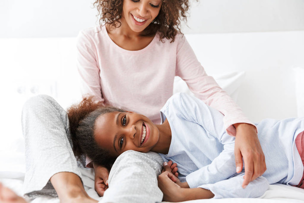 Image of happy african american woman and her little daughter at - Photo, Image