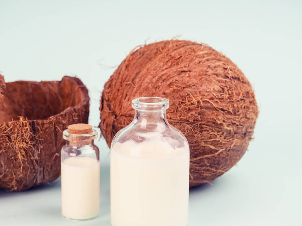Coconut and coconut milk on blue table. Coconut oil with fresh n - Photo, Image