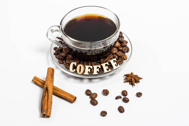 Aromatic tasty coffee in a glass cup and cinnamon next to a white background - Photo, Image