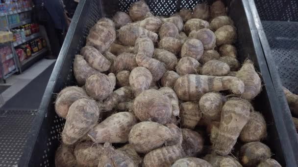 Pile of raw, unpeeled tropical Eddoes on a market stall in the UK - Video